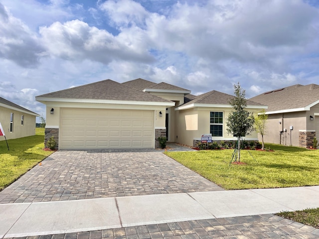 view of front of house featuring a garage, central AC, and a front lawn