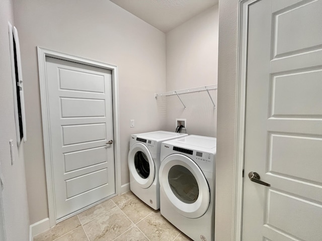 clothes washing area featuring washer and clothes dryer