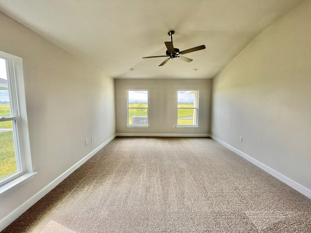 carpeted spare room featuring lofted ceiling and ceiling fan