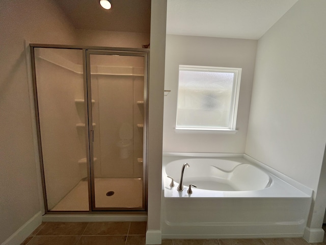 bathroom featuring plus walk in shower and tile patterned flooring