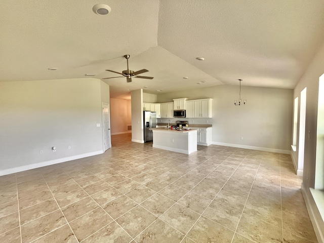 unfurnished living room with ceiling fan with notable chandelier, lofted ceiling, sink, light tile patterned floors, and a textured ceiling