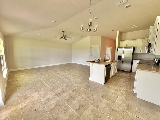 kitchen featuring lofted ceiling, sink, an island with sink, stainless steel appliances, and white cabinets