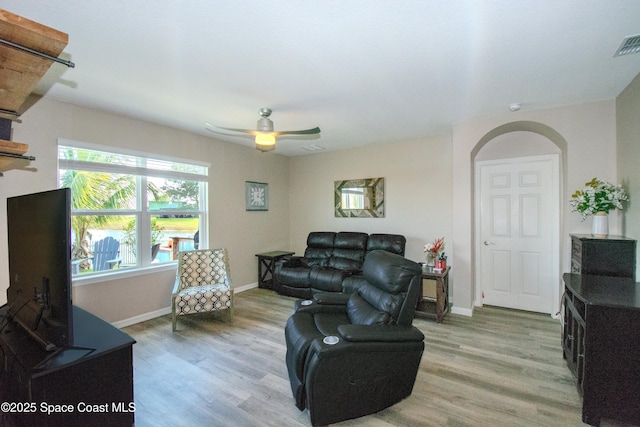 living room featuring hardwood / wood-style flooring and ceiling fan