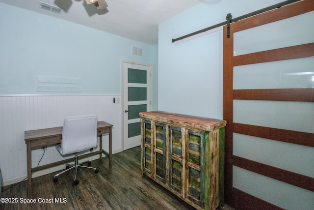 office with dark hardwood / wood-style floors and a barn door