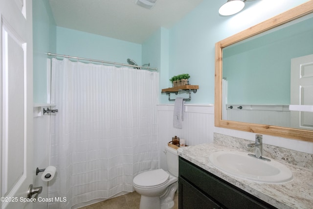 bathroom featuring vanity, curtained shower, tile patterned floors, and toilet