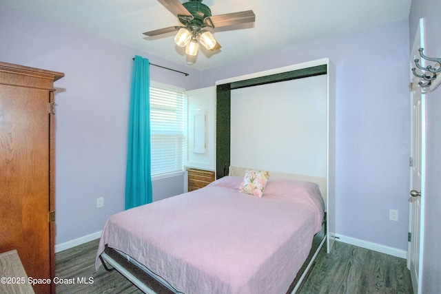 bedroom with dark hardwood / wood-style flooring and ceiling fan