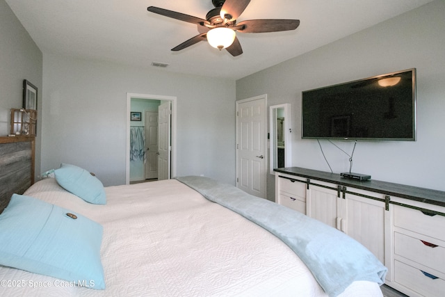 bedroom with ceiling fan and ensuite bath