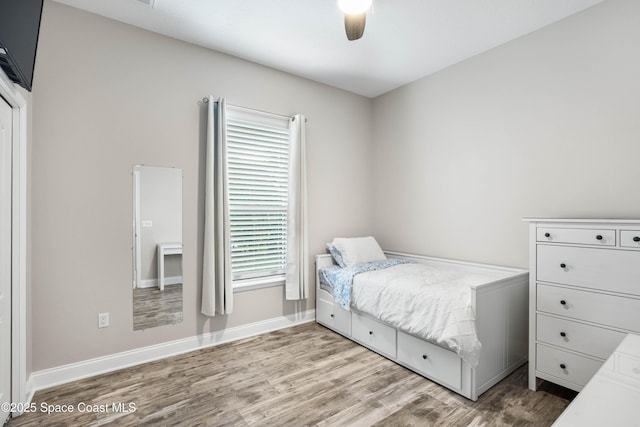 bedroom with light hardwood / wood-style floors and ceiling fan