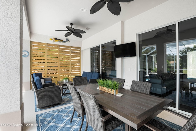 view of patio / terrace featuring outdoor lounge area, ceiling fan, and glass enclosure