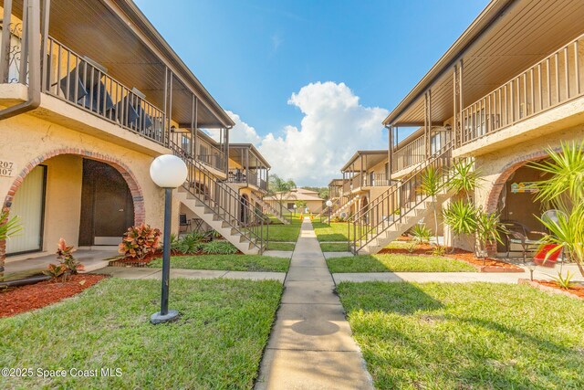 view of property's community with a lawn