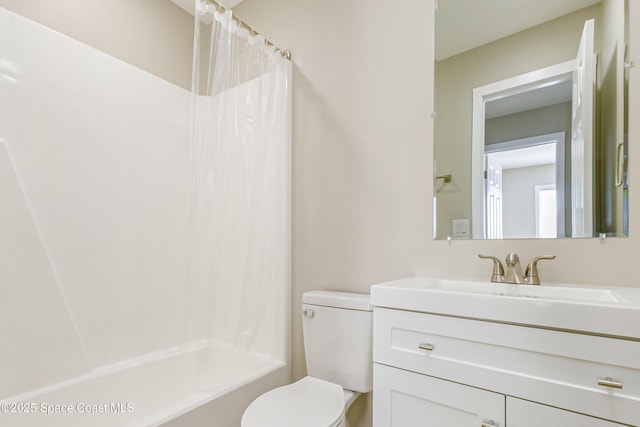 full bathroom featuring vanity, shower / tub combo, and toilet