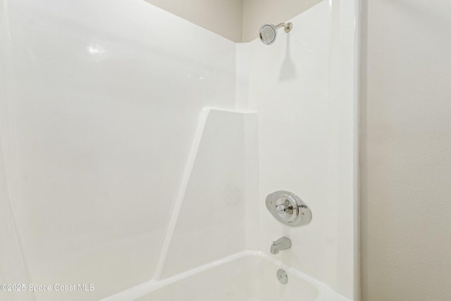 bathroom with bathing tub / shower combination