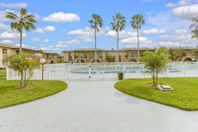 view of pool featuring a lawn