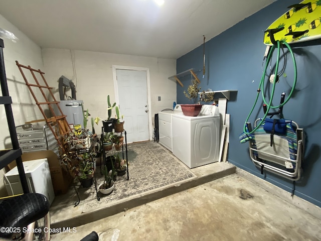 laundry area with washing machine and dryer and electric water heater