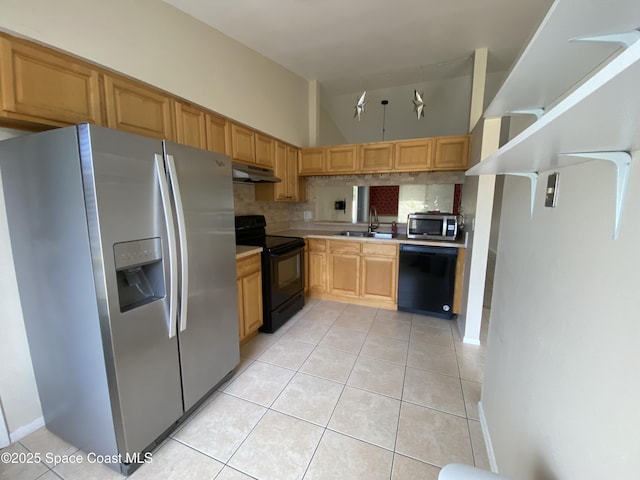 kitchen with light tile patterned flooring, sink, black appliances, vaulted ceiling, and backsplash