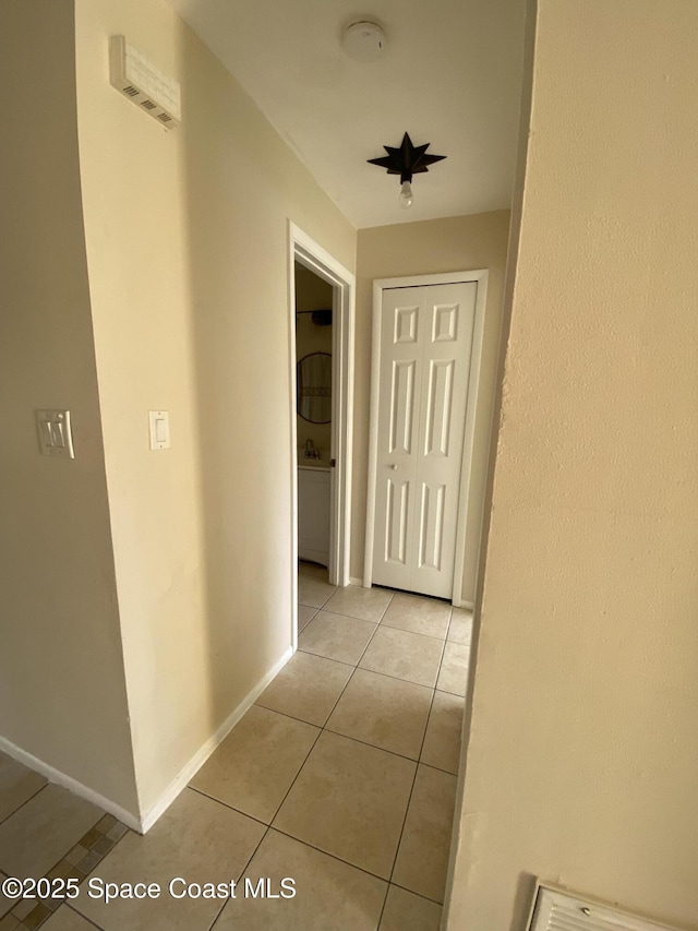 hall with light tile patterned flooring