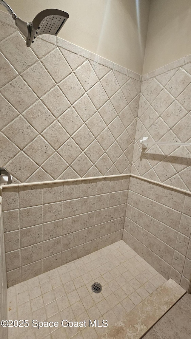 bathroom with tiled shower