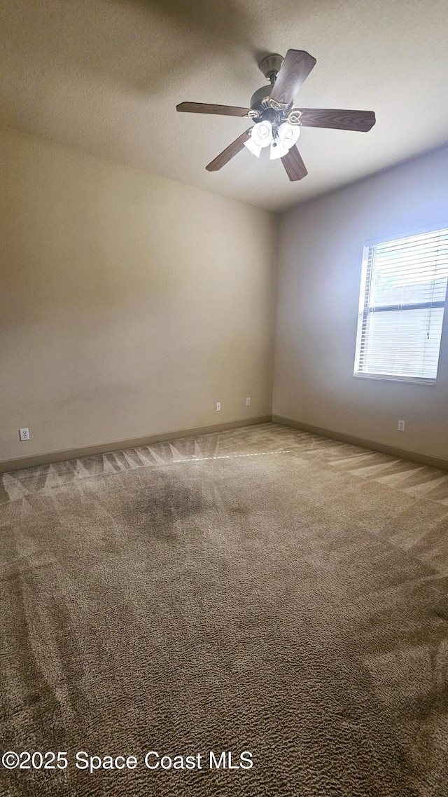 carpeted empty room with ceiling fan