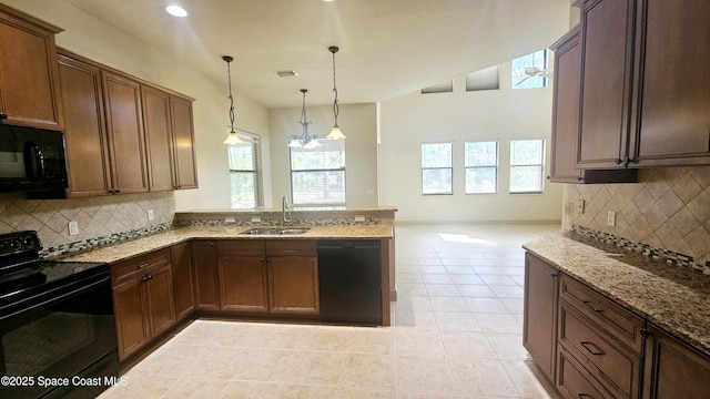 kitchen with sink, light tile patterned floors, hanging light fixtures, black appliances, and light stone countertops