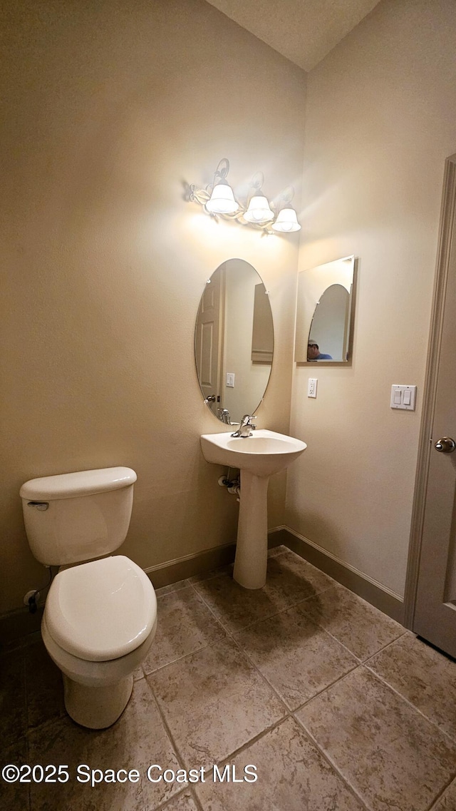 bathroom with tile patterned floors and toilet