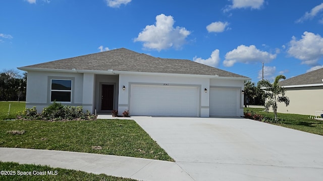 view of front of property featuring a garage and a front lawn