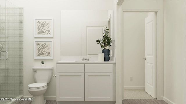 bathroom with vanity, toilet, and walk in shower