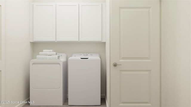 laundry area featuring cabinets and washer and dryer