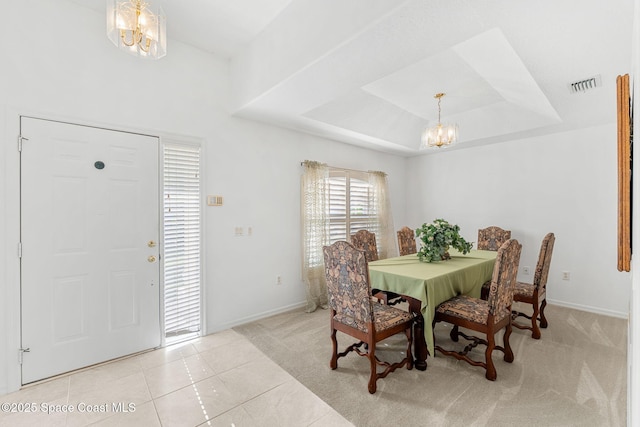926 Pine Creek Cir NE, Palm Bay, FL 32905 - carpeted dining room featuring a chandelier, tile patterned flooring, and a raised ceiling