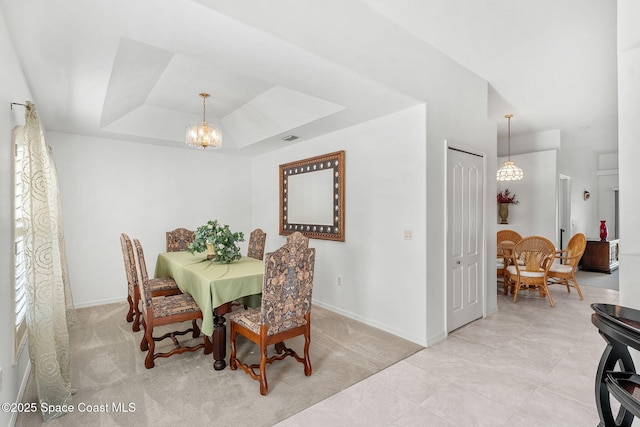 926 Pine Creek Cir NE, Palm Bay, FL 32905 - dining area with a chandelier, a raised ceiling, and light colored carpet