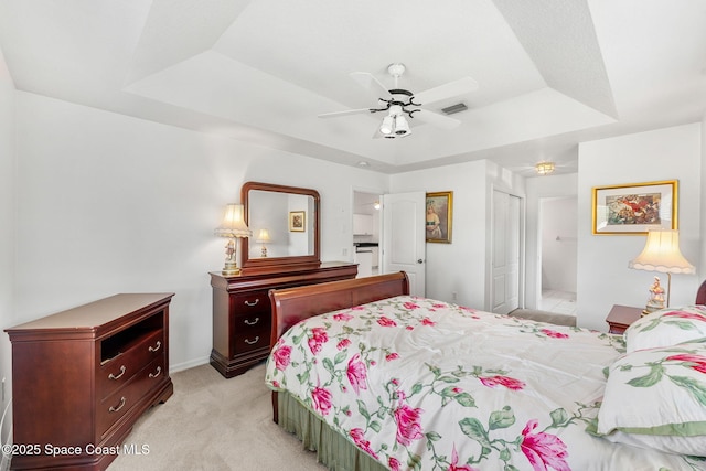 926 Pine Creek Cir NE, Palm Bay, FL 32905 - bedroom with a raised ceiling, light colored carpet, a closet, and a ceiling fan