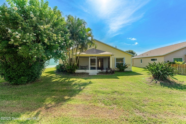 926 Pine Creek Cir NE, Palm Bay, FL 32905 - back of property featuring a yard, a sunroom, and stucco siding