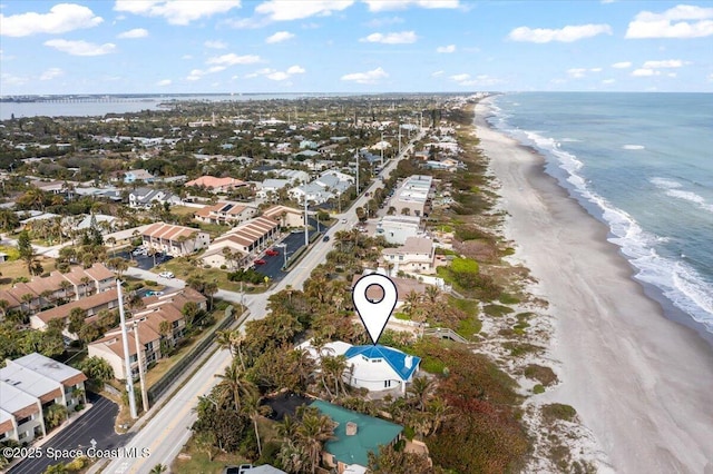 drone / aerial view with a beach view and a water view