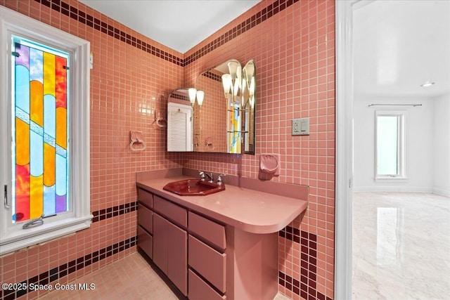 bathroom with vanity and tile walls