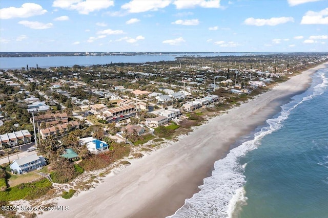 birds eye view of property with a view of the beach and a water view