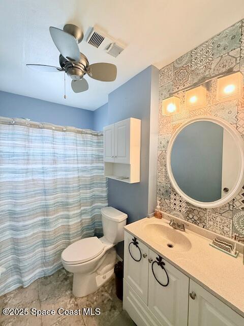 bathroom with ceiling fan, vanity, a shower with curtain, tile patterned floors, and toilet