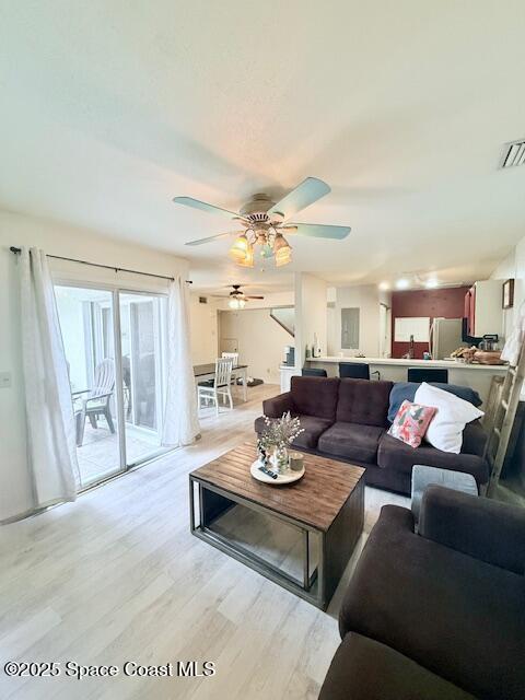 living room with ceiling fan and light hardwood / wood-style floors