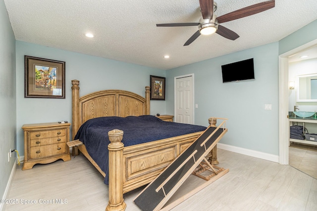 bedroom with ceiling fan, hardwood / wood-style flooring, a closet, and a textured ceiling