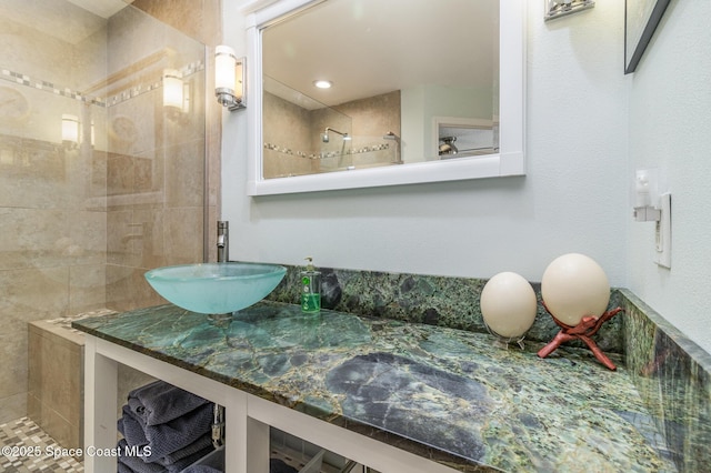 bathroom with sink and tiled shower