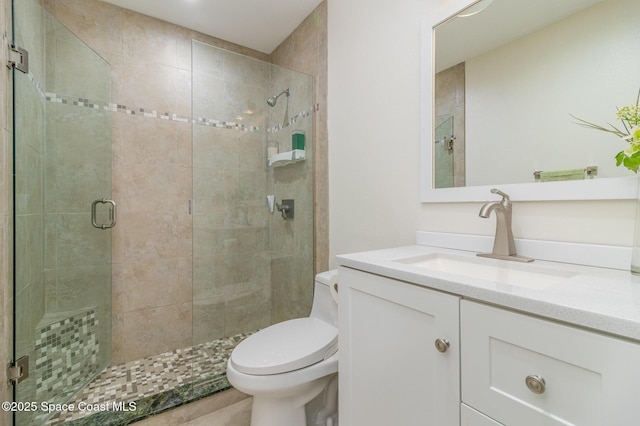 bathroom featuring walk in shower, vanity, and toilet