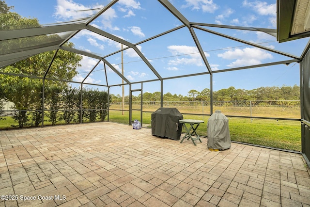 view of patio with a lanai and a grill