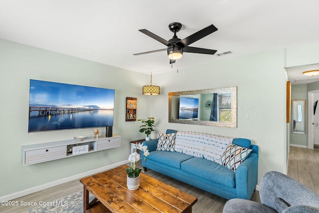 living room with hardwood / wood-style flooring and ceiling fan