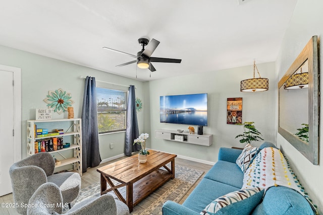 living room featuring hardwood / wood-style floors and ceiling fan