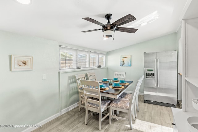 dining space featuring ceiling fan and vaulted ceiling