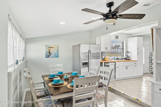 dining space with ceiling fan and sink