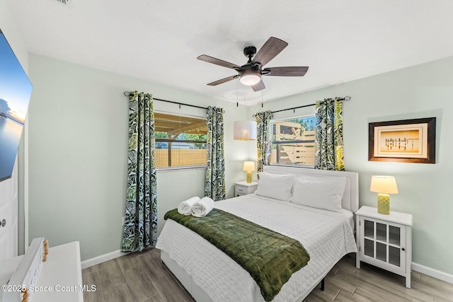 bedroom featuring multiple windows and ceiling fan