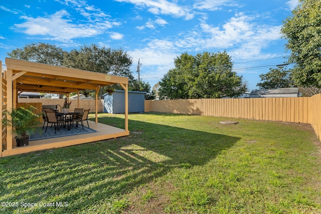 view of yard featuring a wooden deck and a shed