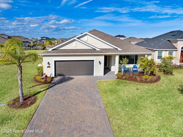 ranch-style home featuring a garage, a front yard, and covered porch