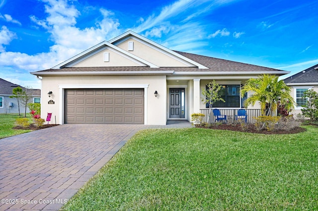 single story home featuring a garage, a front yard, and covered porch