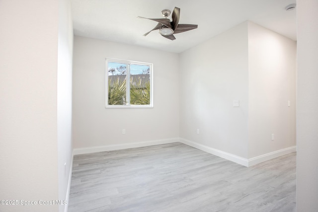 empty room with ceiling fan and light hardwood / wood-style floors