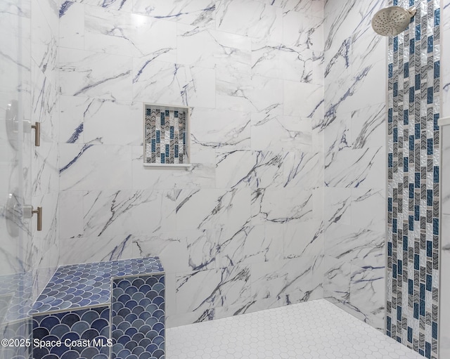 bathroom with a tile shower